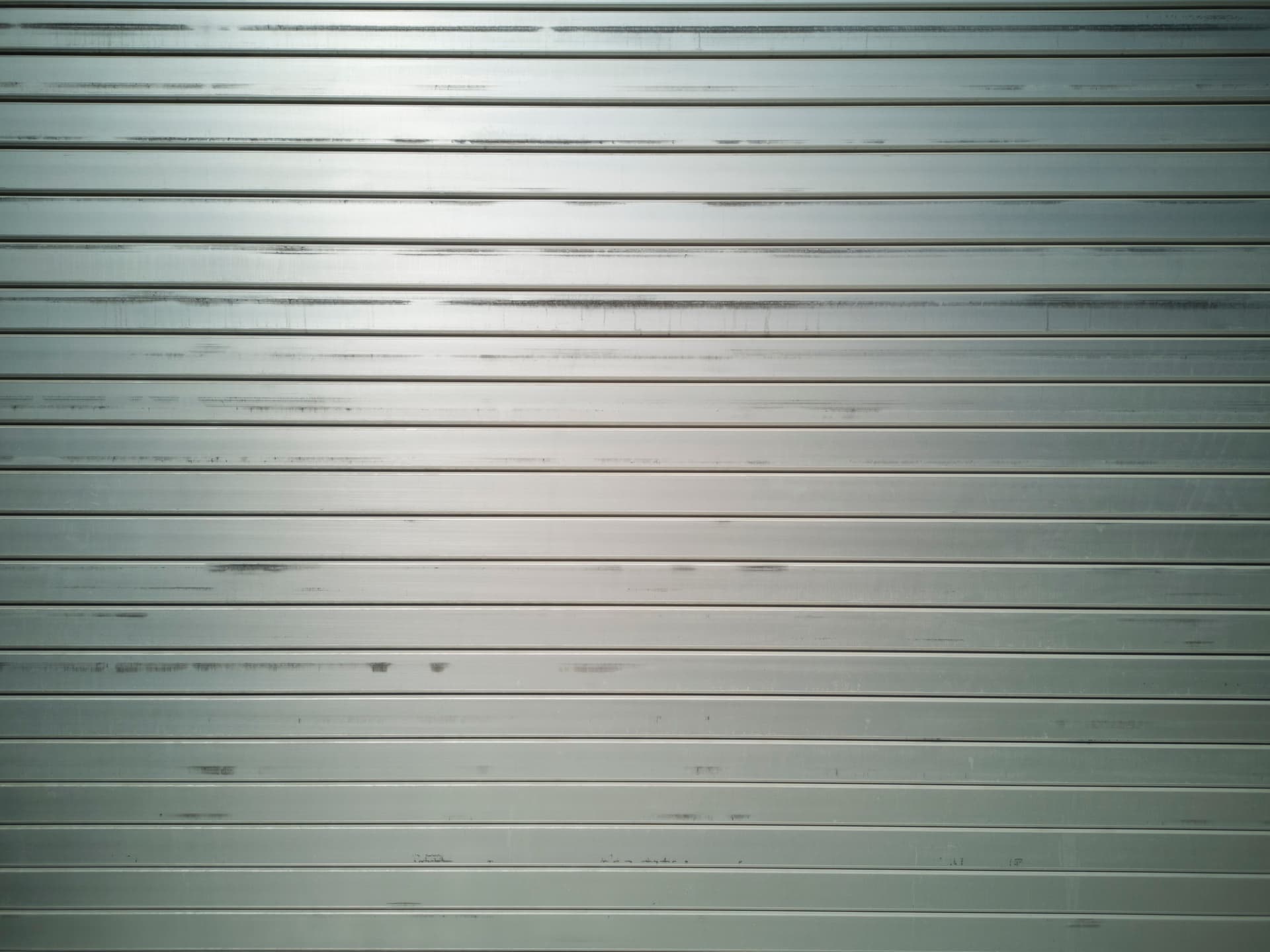 A sheet of brushed aluminum resting on a workbench