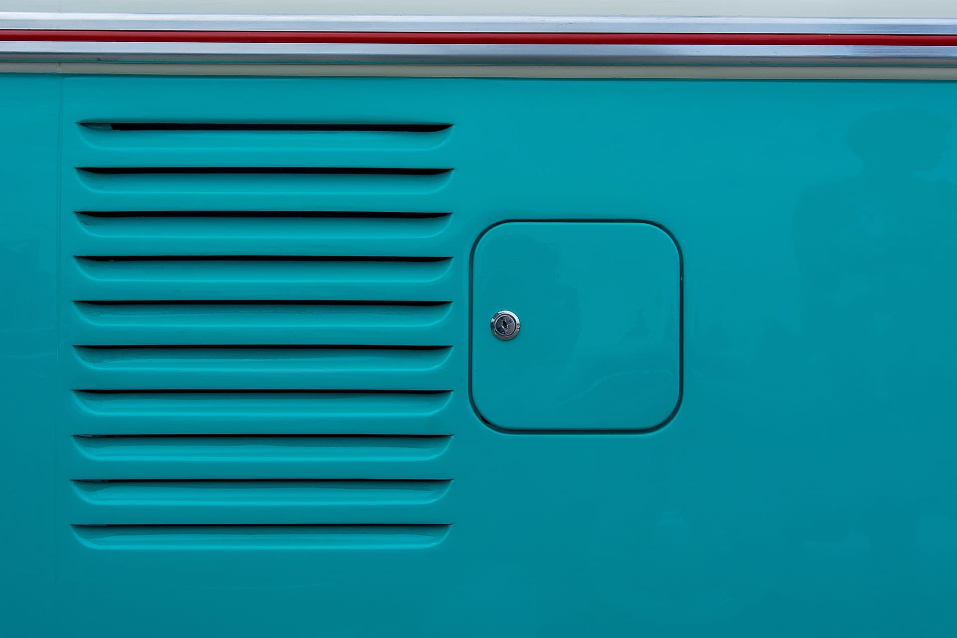 A thin sheet steel panel resting on a workbench in daylight