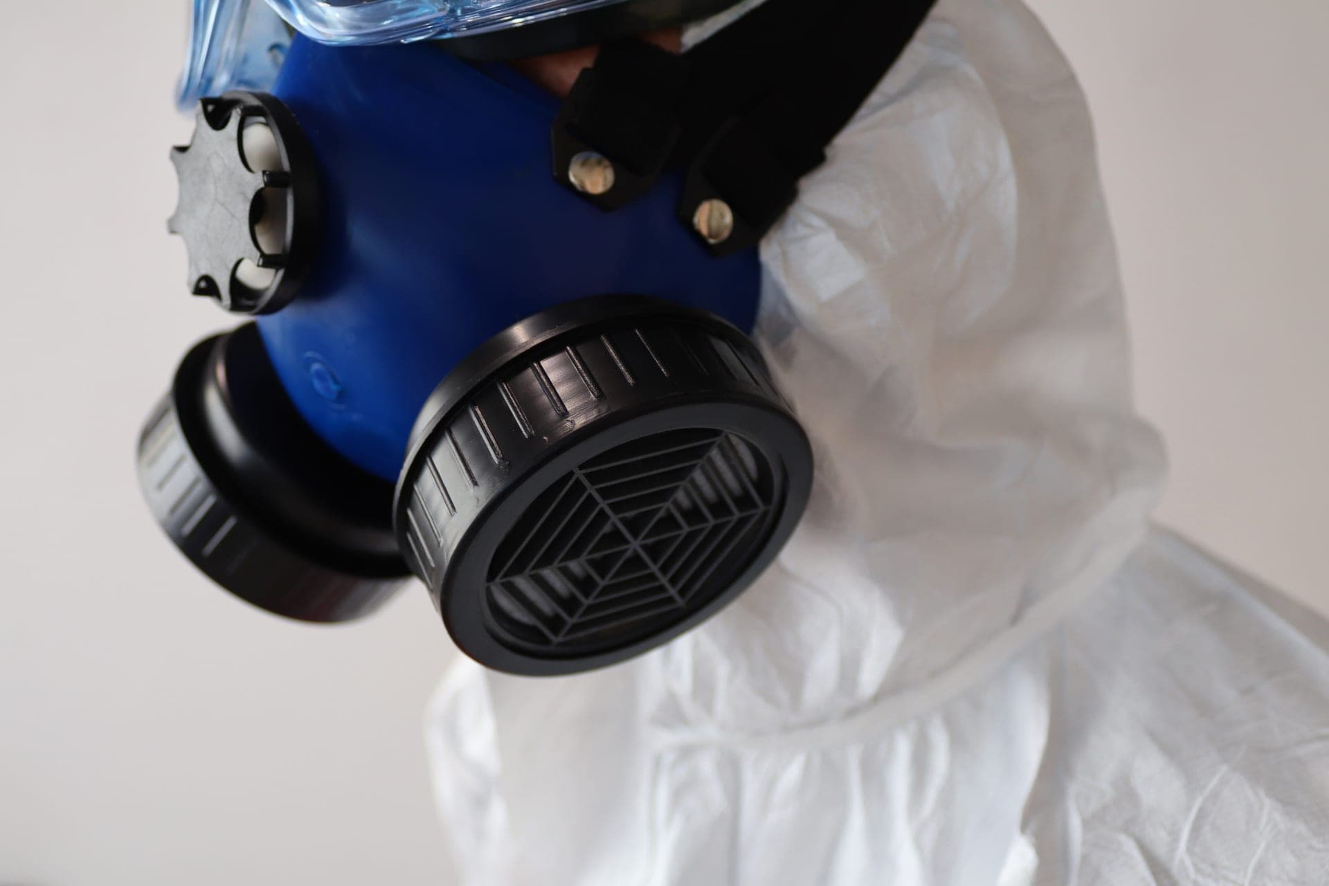 A half-mask respirator with particulate filters resting on a clean bench
