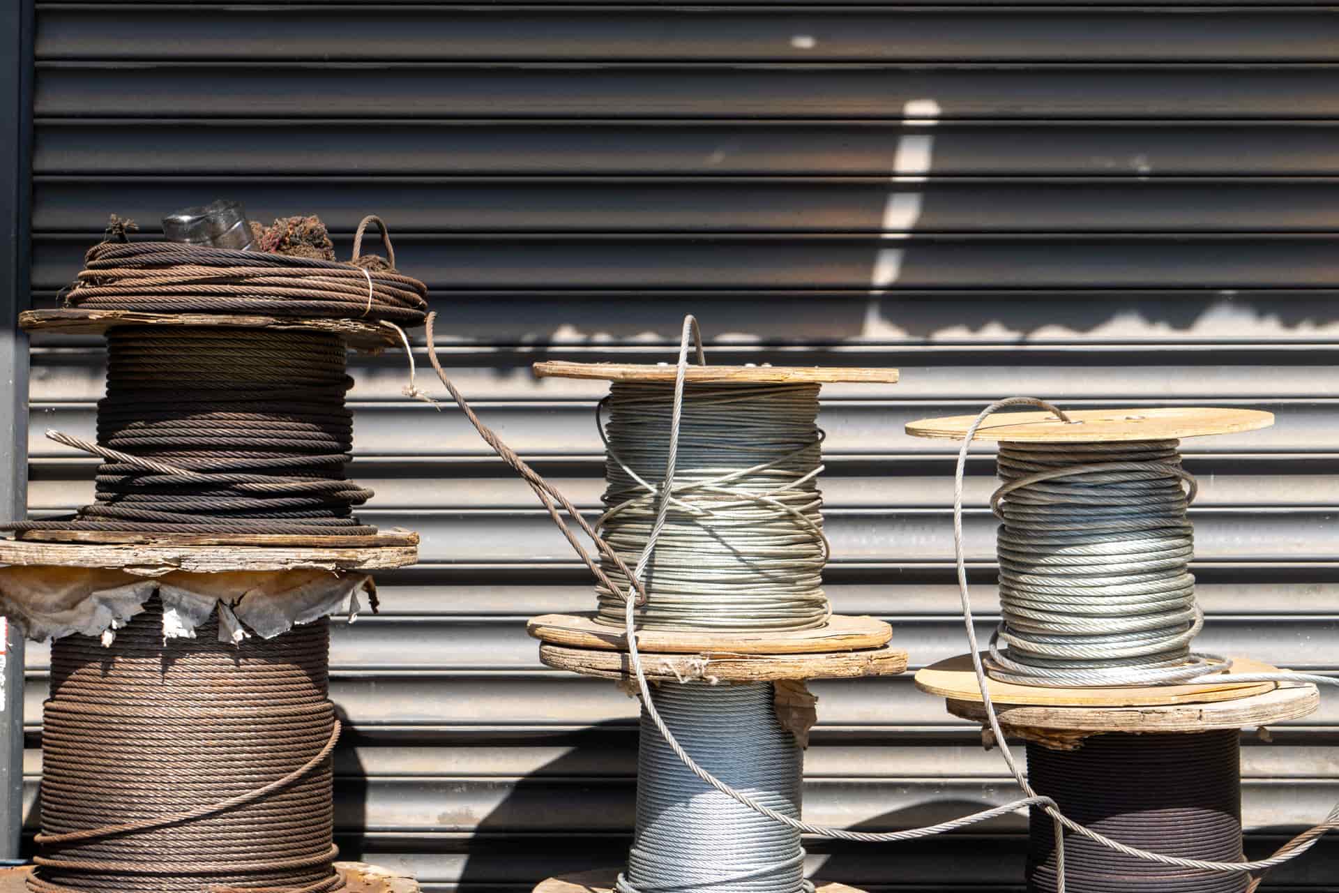 Spools of welding wire standing on a light workbench
